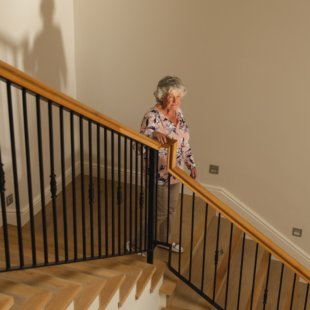 Older woman confident on the stairs Older woman confidently walking down stairs