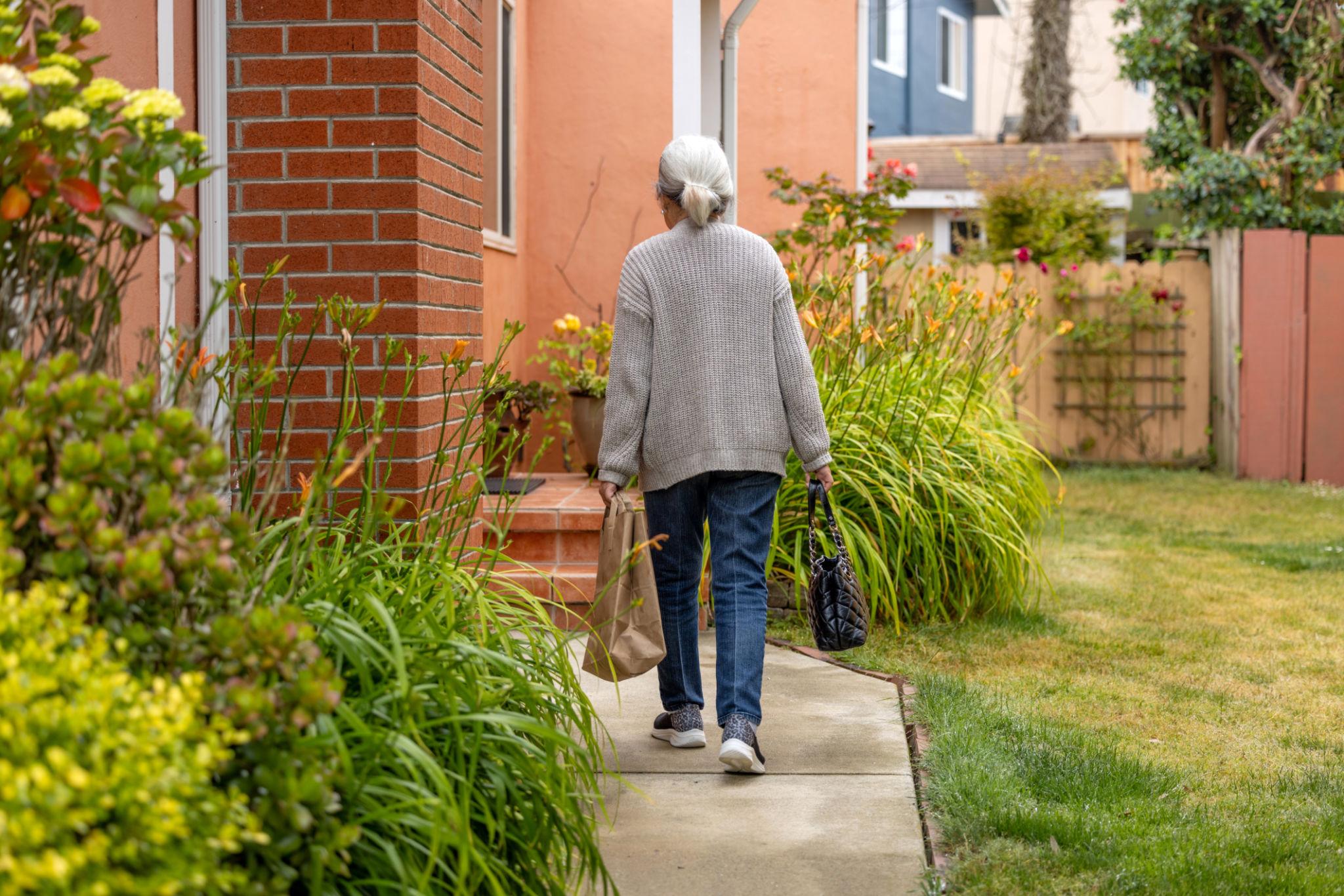 Woman carrying groceries Older woman carrying groceries independently