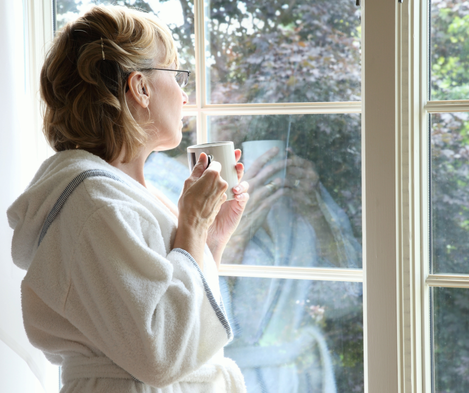 Woman thinking at window Woman overwhelmed by all the health and fitness noise